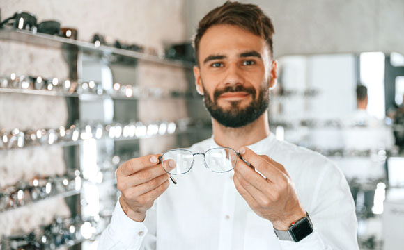 Hombre sosteniendo unas gafas